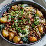 Savory Black-Eyed Pea Skillet Dinner served warm from the oven with a bright garnish of fresh parsley and lemon wedges.
