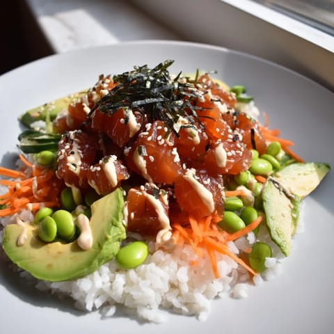 Close-up of a delicious poke bowl featuring marinated tuna, rice, and edible seaweed strips.