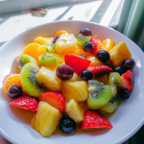 Fresh, colorful fruit salad bursting with sweet and tangy flavors, perfect for a summer dessert.