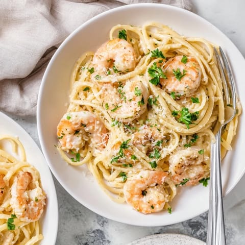 Creamy Garlic Shrimp Pasta features succulent shrimp coated in a rich garlic cream sauce, served over steaming linguine.
