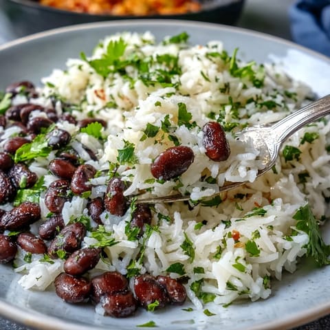 Fluffy Coconut Lime Rice with black beans and fresh cilantro, a vibrant side.