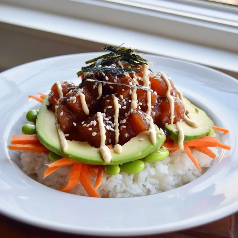 Vibrant image shows a homemade poke bowl with glistening fish, perfect for a light dinner.