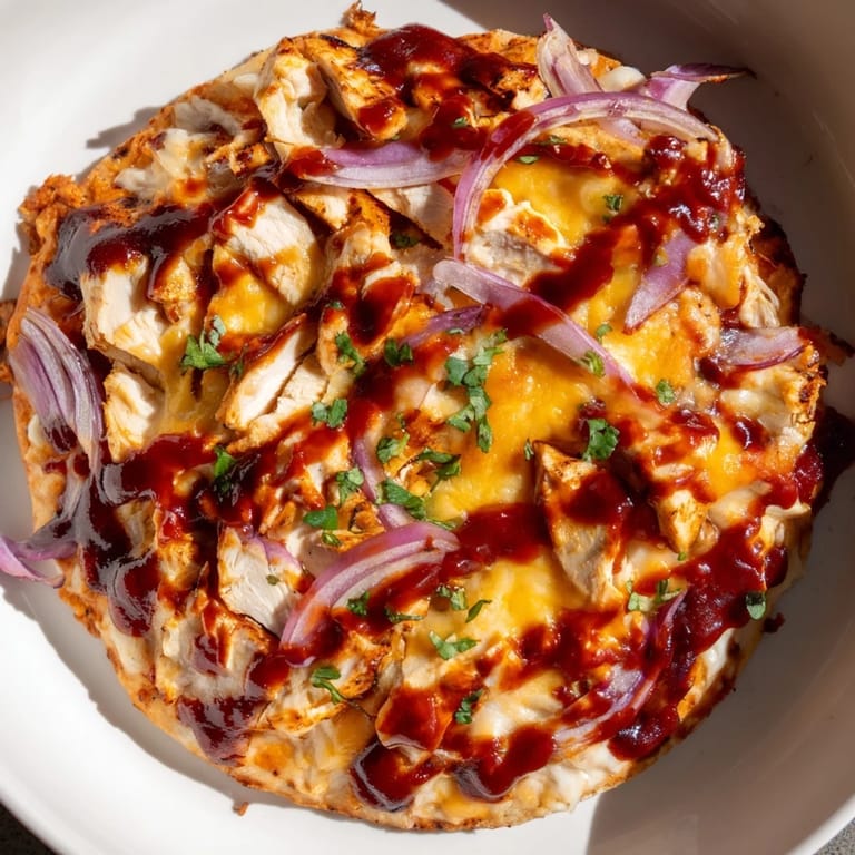 Homemade Chicken BBQ Pizza boasting a vibrant, tangy barbecue sauce base, perfect for sharing and easy to make.