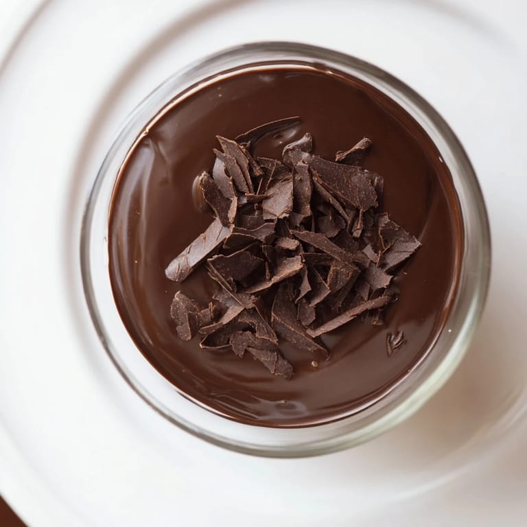 Silky smooth, dark chocolate pudding, chilled and perfectly portioned in clear glass cups.