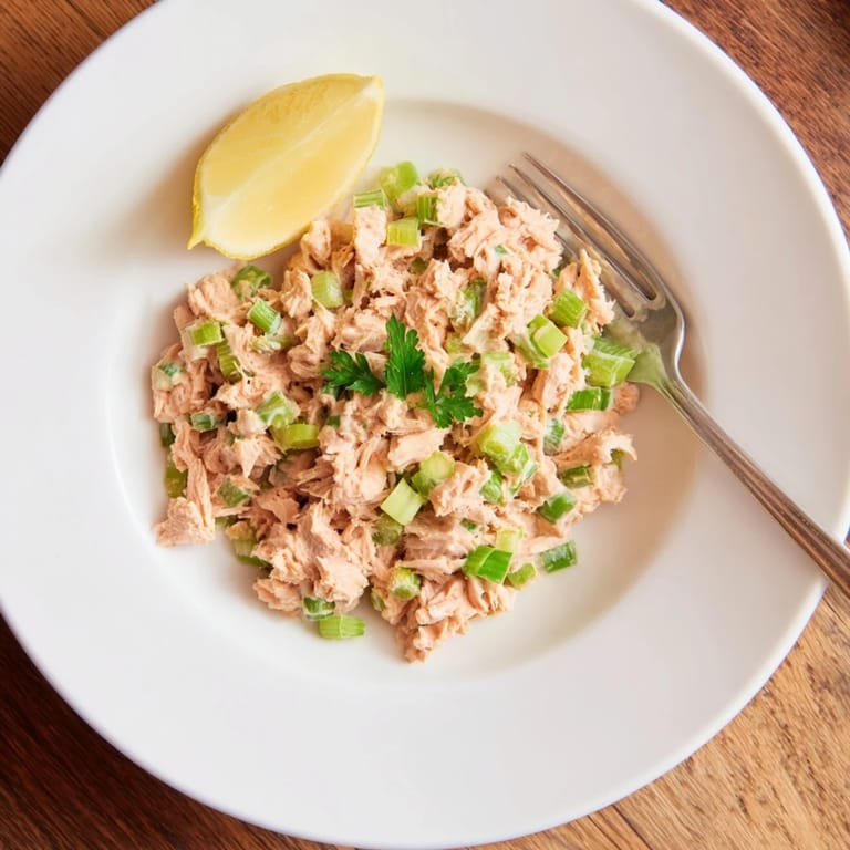 Serving suggestion for Spicy Zesty Tuna Salad piled high on toasted artisan bread.