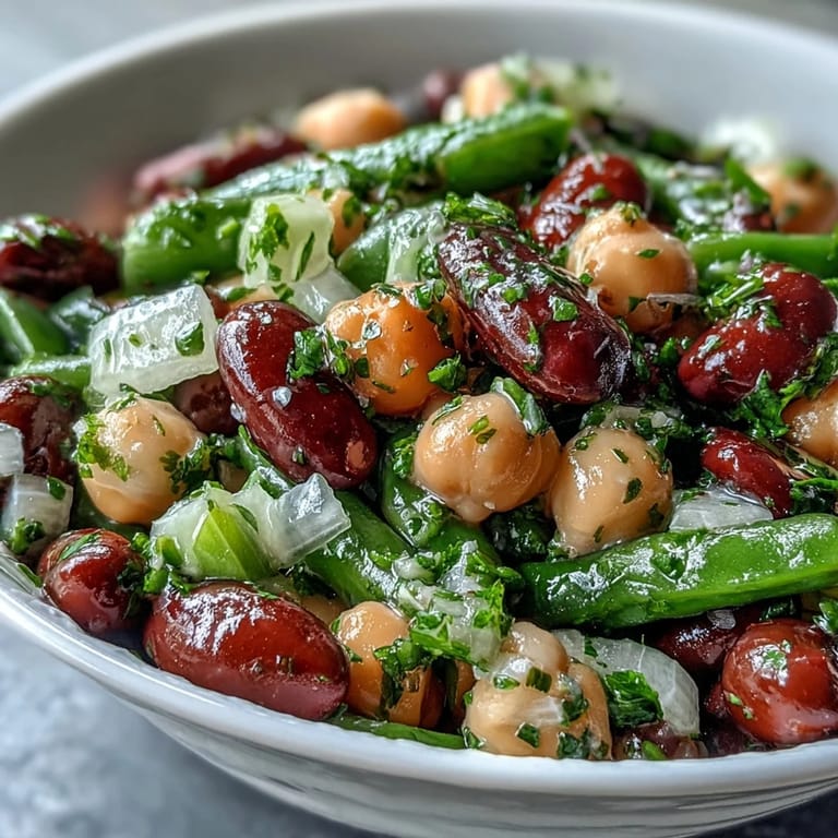 Vibrant Three-Bean Salad salad overflowing with fresh veggies and hearty beans, ready to serve.