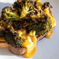 Golden toasted sourdough slices encasing melted sharp cheddar and tender, caramelized roasted broccoli florets in this Roasted Broccoli & Cheddar Grilled Cheese.