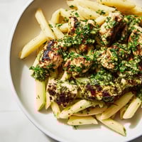 Grilled chicken strips and al dente penne tossed in a vibrant, herb-packed chimichurri sauce, served warm with lemon wedges for a zesty, dairy-free meal.