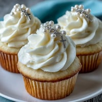 Mini First Communion Cupcakes with Rosary Fondant Toppers: delicate vanilla cupcakes topped with smooth buttercream and elegant fondant rosary toppers, perfect for a sacred celebration.